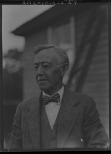 Image of Man wearing bow tie, by frame building